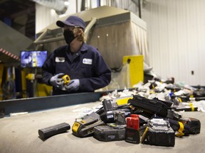 A worker sorts batteries at the Li-Cycle lithium-ion battery recycling facility in Kingston, Ont.