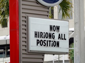 A 'now hiring' sign outside of a business on October 8, 2021 in Miami, Florida.