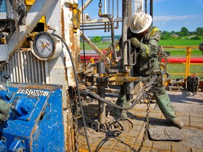 A worker test drilling for natural gas in Quebec.