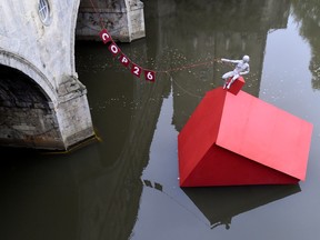 An installation of a 'Sinking House' is partly submerged to highlight climate change, ahead of COP26, in Bath, Britain, October 26, 2021.