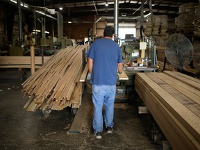 A worker stacks lumber in Kentucky. In the U.S. South, where a large amount of North America's lumber is produced, labour issues are plaguing the mills.
