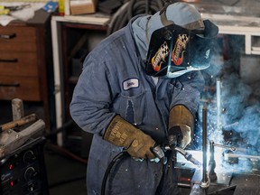 A worker welds a steel girder at the International Hi-Tech Industries facility in Delta, British Columbia.