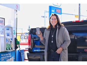 Alice Reimer, CEO of Fillip Fleet demonstrates the use of the Fillip Fleet app, a new fee-free fuel and fleet services app designed for small businesses, at a Calgary-area Husky station.