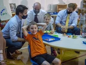 Prime Minister Justin Trudeau, Education Minister Tom Osborne and Newfoundland and Labrador Premier Andrew Furey engage with children at the College of the North Atlantic in St. John's, N.L. on July 28, 2021.