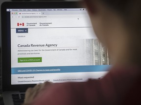 A person looks at a Canada Revenue Agency homepage in Montreal on Aug. 16, 2020.
