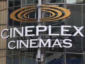 A Cineplex movie theatre sign looms over Yonge street in Toronto on March 16, 2020.