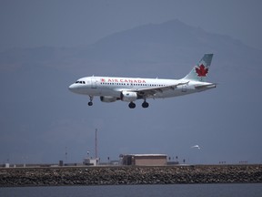 An Air Canada plane lands at San Francisco International Airport from Vancouver on June 30, 2020 in San Francisco, California.