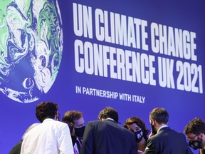 Delegates talk during the COP26 in Glasgow, Scotland, Nov. 13, 2021.