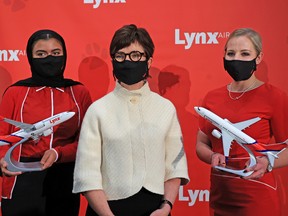 Merren McArthur, CEO of new airline Lynx Air, with flight attendants at the airline's launch at the Calgary International Airport on Nov. 16, 2021.