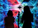 Visitors in front of an immersive art installation titled 'Machine Hallucinations - Space: Metaverse' by media artist Refik Anadol, which will be converted into NFT and auctioned online at Sotheby's, at the Digital Art Fair, in Hong Kong, China on Sept. 30, 2021. 