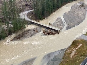 A swollen creek flows under a washed out bridge at the Carolin Mine interchange with Coquihalla Highway 5 after devastating rain storms caused flooding and landslides near Hope, B.C., on Nov. 17, 2021.