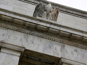 An eagle tops the U.S. Federal Reserve building's facade in Washington, July 31, 2013.