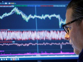 A trader works inside a booth on the floor of the New York Stock Exchange in New York City, U.S., Nov. 8, 2021.