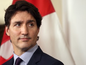 Prime Minister Justin Trudeau talks to media about the recent flooding in the province at the legislature during a press conference in Victoria, B.C., on Nov. 26, 2021.