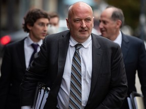 Lawyer Ken McEwan, who is representing former Rogers Communications chairman Edward Rogers, walks into the B.C. Supreme Court in Vancouver Monday.