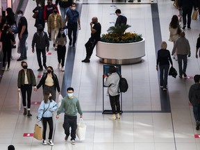 Shoppers walk around the Eaton Centre in downtown in Toronto.