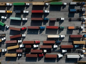 Trucks are backed up waiting to transport cargo containers at the Port of Baltimore. Closed factories, clogged ports, no truck drivers — up and down the global supply chain there are problems, raising concerns that it could disrupt the global economic recovery.