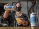 Angie Billson, taproom manager for The People's Pint brewery in Toronto, pours a can of Brave Noise beer.
[Peter J Thompson]  [National Post story by TBA/National Post]