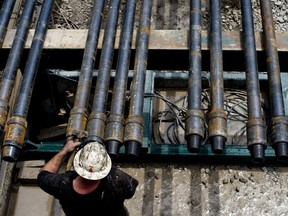 A drill hand prepares drill pipe for a shale-gas well in the U.S.