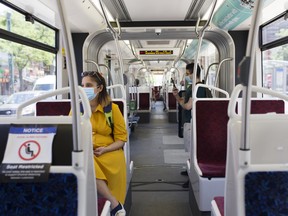 Passengers wearing protective masks ride a streetcar in Toronto.