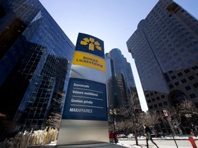Pedestrians walk past the head offices of Laurentian Bank in Montreal.
