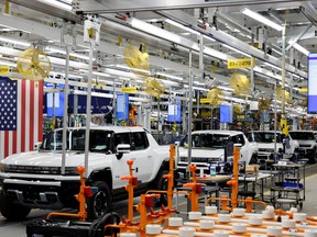 Hummer EV are seen on the production line as U.S. President Joe Biden tours the General Motors 'Factory ZERO' electric vehicle assembly plant, in Detroit last month. Canada is protesting tax incentives for electric vehicles produced by unionized American workers in the Build Back Better Act.