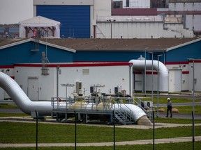 A worker passes pipework at the Nord Stream 2 gas receiving station in Lubmin, Germany, on Nov. 12, 2021.