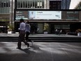 Pedestrians pass in front of the Toronto Stock Exchange in the financial district of Toronto on Sept 16, 2021.