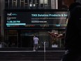 Pedestrians pass in front of the Toronto Stock Exchange in the financial district of Toronto on Sept 16, 2021.