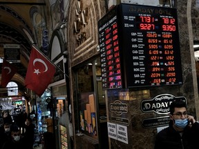 A board shows the currency exchange rates outside an exchange office in Istanbul, Turkey, March 22, 2021.