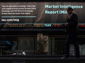 A pedestrian passes front of the Toronto Stock Exchange in the financial district of Toronto on Sept. 16, 2021.