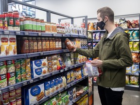 A customer shops at an Aisle 24 grocery store in Montreal on Nov. 1, 2021.