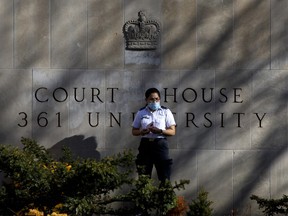 A security guard stands outside the Superior Court of Justice in Toronto.