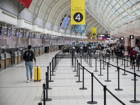 Travelers at Toronto Pearson International Airport in Toronto, on Dec. 16, 2021.