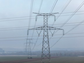 High voltage electricity pylons on farmland near the Nogent nuclear power plant, operated by Électricité de France SA (EDF), in Nogent-sur-Seine, France, December 21, 2021.