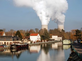 Cooling towers release water vapor at the Nogent nuclear power plant, operated by Electricite de France SA (EDF), in Nogent-sur-Seine, France, on Tuesday, Dec. 21, 2021.