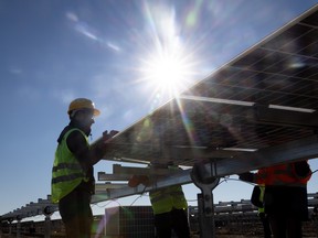 An employee installs new solar panels in Turkey.