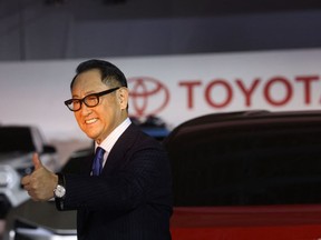 Toyota president Akio Toyoda gives a thumbs up as he speaks during a briefing on electric vehicle battery strategies in Tokyo on Dec. 14, 2021.