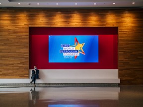 A person waits in the lobby during the 23rd World Petroleum Congress conference at the George R. Brown Convention Center on Dec. 7, 2021, in Houston, Texas.