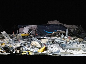 A damaged Amazon truck is seen at the site of a roof that collapsed at the Amazon distribution centre in Edwardsville, Illinois.