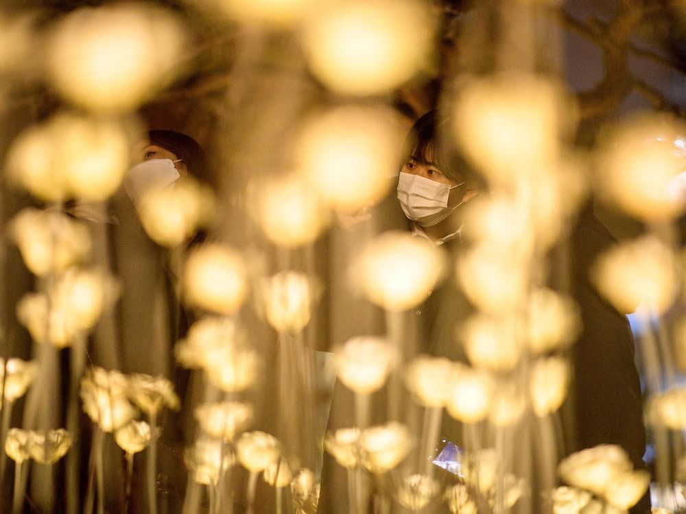 People visit a Christmas light installation in Seoul on December 22, 2021.