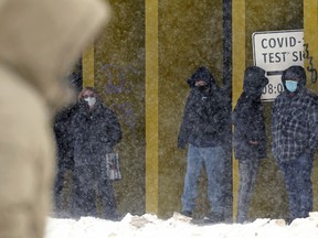 People line up outside a COVID-10 testing site in downtown Winnipeg this week.