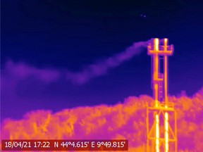 A handout screen grab from thermographic video footage shot on April 18, 2021 with an infrared camera and made available to Reuters on June 10, 2021 by Clean Air Task Force (CATF), shows what appears to be methane gas leaking from two stacks at SNAM's Panigaglia LNG terminal near La Spezia, Italy. CATF found methane seeping into the atmosphere at 123 oil and gas sites visited in seven EU states by placing the infrared camera in public vantage points to detect hydrocarbons such as methane that are invisible to the naked eye.