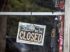 A closed sign on a Toronto storefront door during the COVID-19 pandemic.