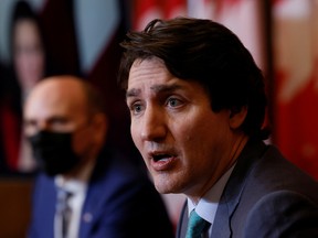 Prime Minister Justin Trudeau, with Minister of Health Jean-Yves Duclos, takes part in a news conference as the latest Omicron variant emerges as a threat amid the COVID-19 pandemic.