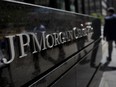 Pedestrians walk by the offices of JPMorgan Chase & Co. in New York.