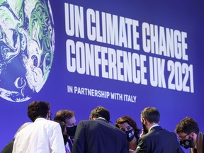 Delegates talk during the UN Climate Change Conference (COP26) in Glasgow, Scotland, Nov. 13, 2021.