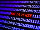 A binary code with the word 'metaverse' displayed on a laptop screen is seen in this multiple exposure illustration photo.