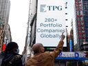 A screen announces the listing of private-equity firm TPG, during the IPO at the Nasdaq Market site in Times Square in New York City, Jan. 13, 2022.  