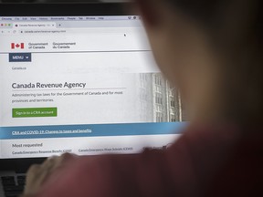 A person looks at a Canada Revenue Agency homepage.